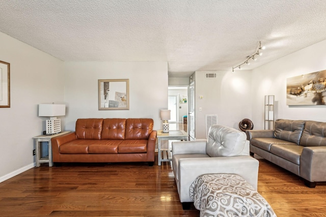 living room featuring dark hardwood / wood-style floors and a textured ceiling