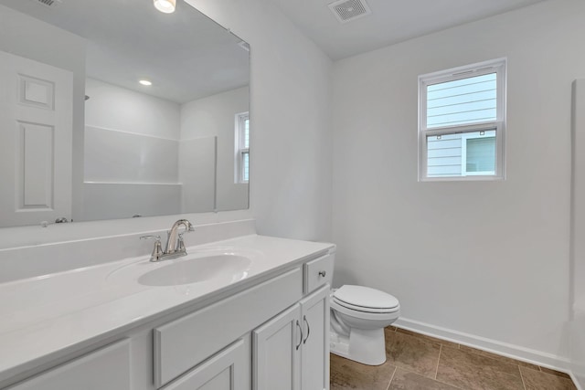 bathroom featuring vanity, toilet, and a shower