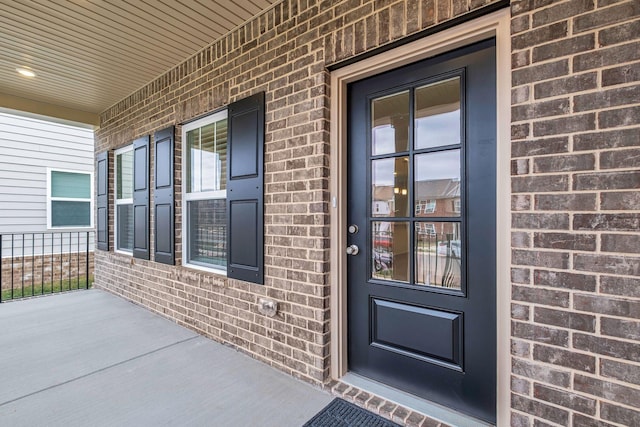 view of exterior entry with a porch