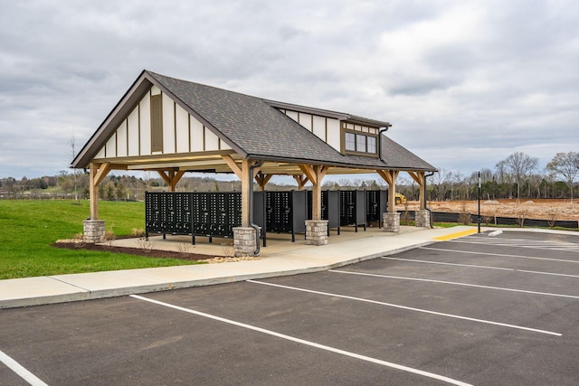 view of parking featuring a lawn and mail boxes