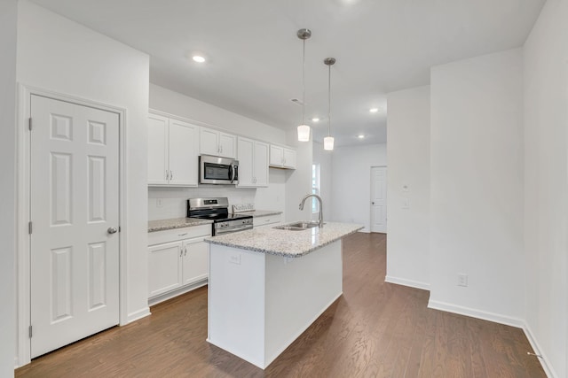 kitchen featuring pendant lighting, an island with sink, white cabinets, stainless steel appliances, and light stone countertops