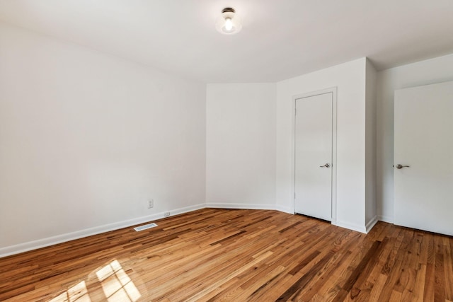 empty room featuring wood-type flooring