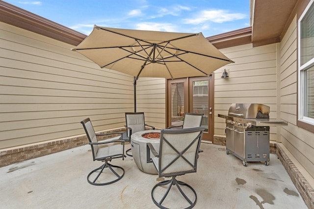 view of patio / terrace with a grill and a fire pit