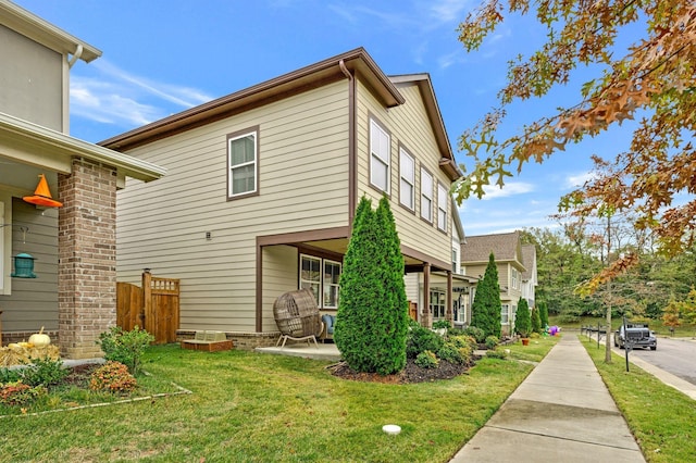 view of home's exterior featuring a lawn and a patio