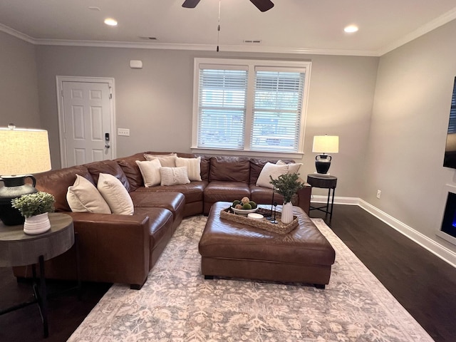 living room with wood-type flooring, ornamental molding, and ceiling fan