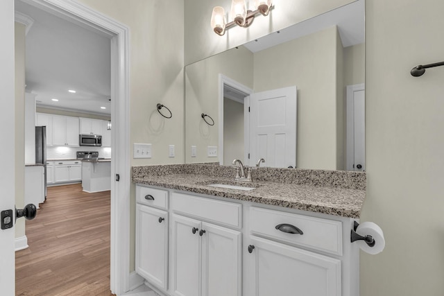 bathroom featuring wood-type flooring and vanity