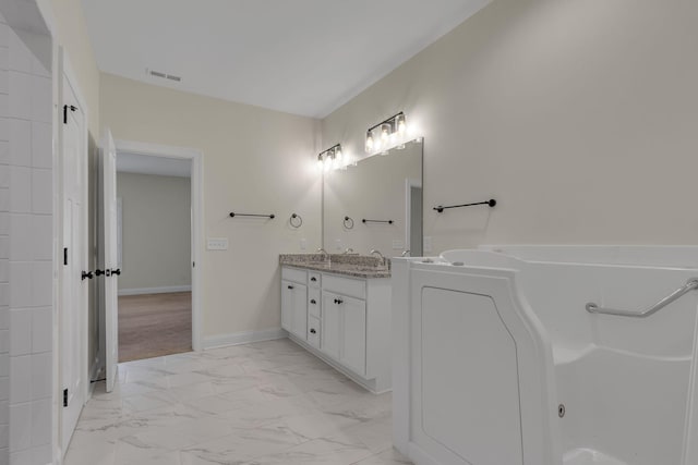 bathroom with vanity and a tub