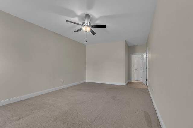 unfurnished room featuring ceiling fan and light colored carpet