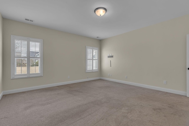 carpeted empty room with a healthy amount of sunlight