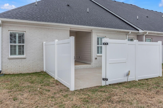 back of property with a patio area and a lawn