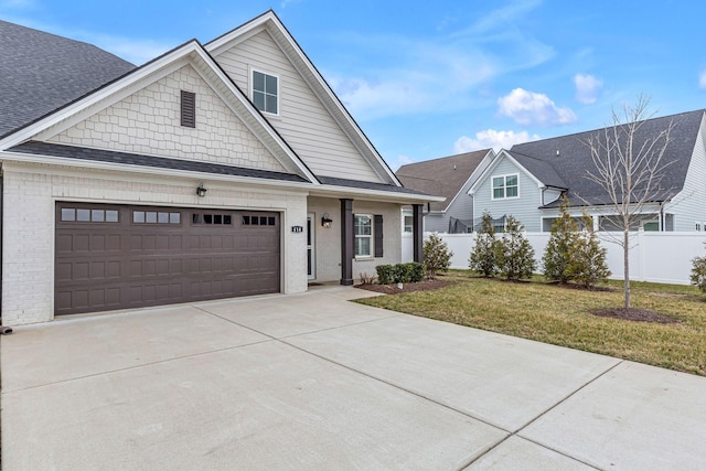 view of front of property featuring a garage and a front lawn