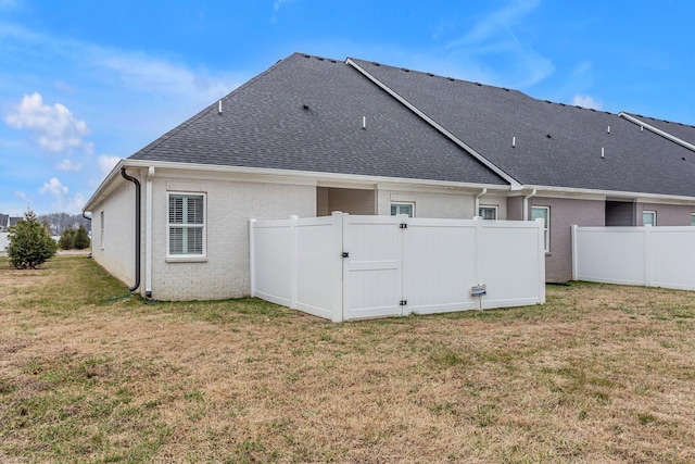 rear view of house with a yard