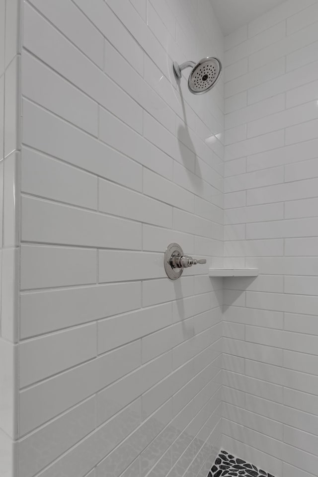 bathroom with a tile shower