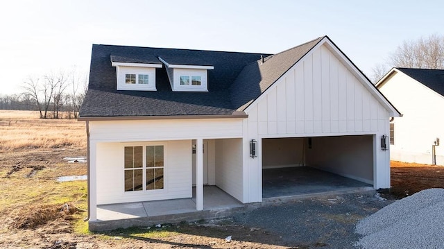 view of front of house featuring a garage and a patio area