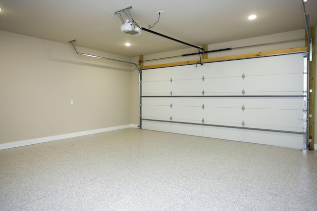 garage featuring recessed lighting, a garage door opener, and baseboards