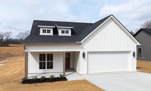 modern inspired farmhouse with an attached garage, board and batten siding, driveway, and roof with shingles