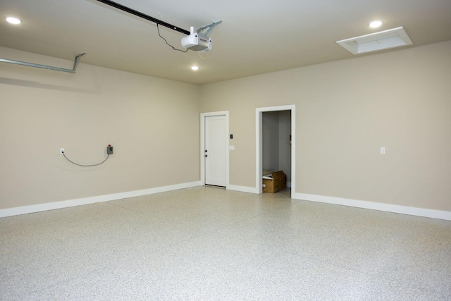 garage featuring recessed lighting, baseboards, and a garage door opener