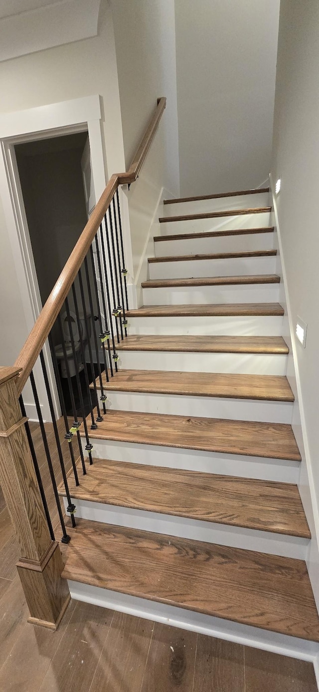 stairs with hardwood / wood-style flooring