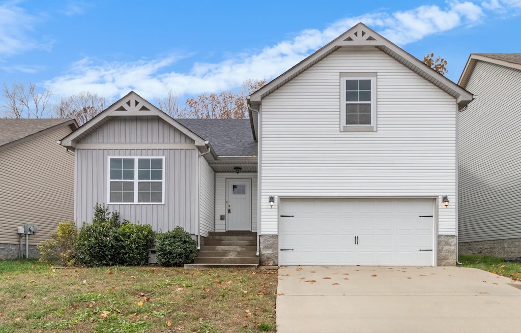 view of front of house with a garage and a front lawn