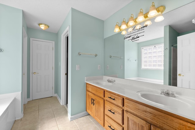 full bath with double vanity, tile patterned flooring, a sink, and a bathtub