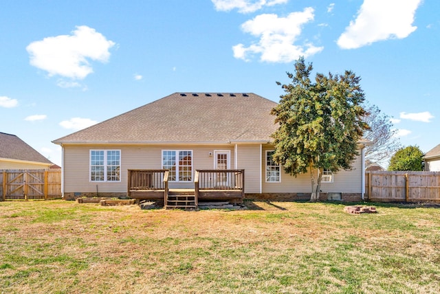 rear view of property featuring crawl space, a fenced backyard, and a lawn