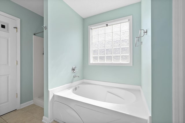 full bathroom with a garden tub, a stall shower, and tile patterned flooring