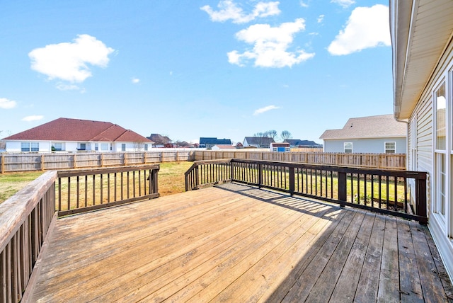 deck featuring a fenced backyard and a lawn