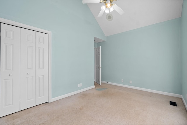 unfurnished bedroom featuring a closet, visible vents, carpet flooring, high vaulted ceiling, and baseboards