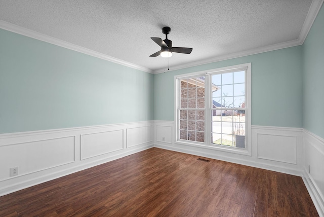 unfurnished room with a ceiling fan, wainscoting, dark wood finished floors, and a textured ceiling