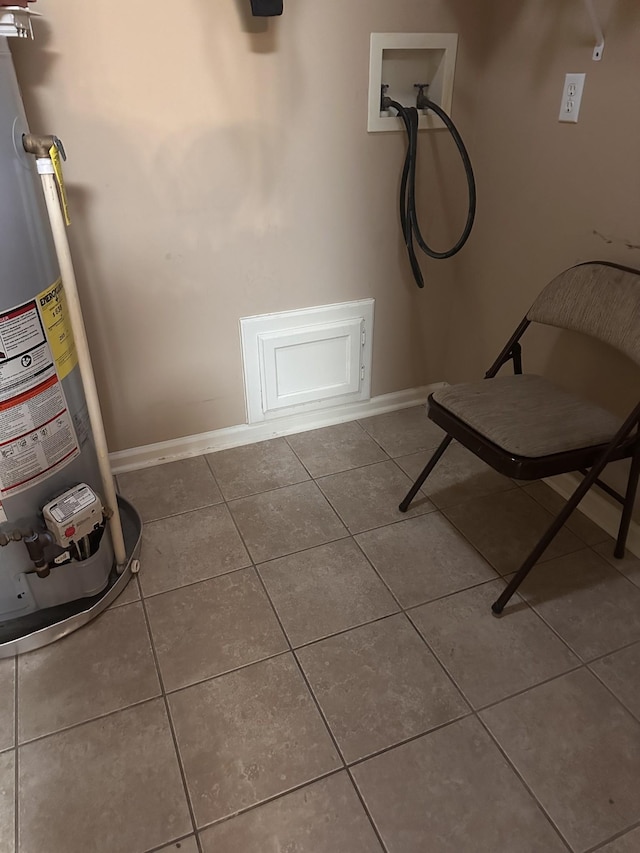 interior space with tile patterned flooring and water heater