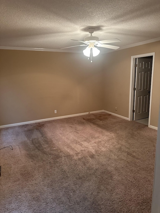 spare room featuring a textured ceiling, ornamental molding, ceiling fan, and carpet flooring