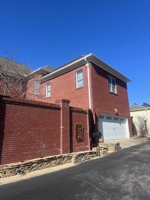 view of side of home with a garage