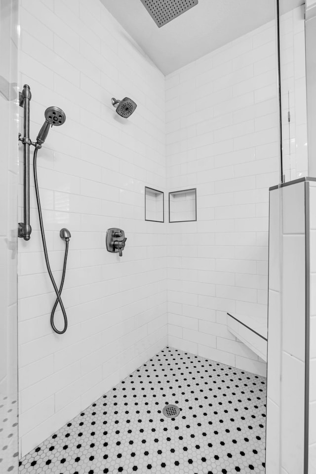 bathroom with tiled shower