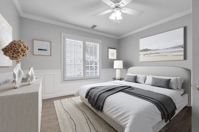 carpeted bedroom with crown molding and ceiling fan