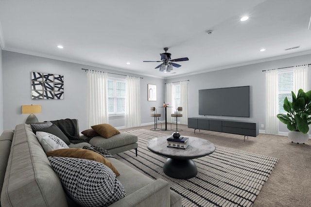 carpeted living room with crown molding and ceiling fan