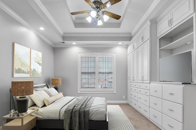 carpeted bedroom with ceiling fan, ornamental molding, and a raised ceiling