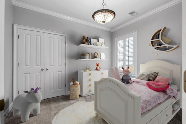 carpeted bedroom with crown molding and a closet