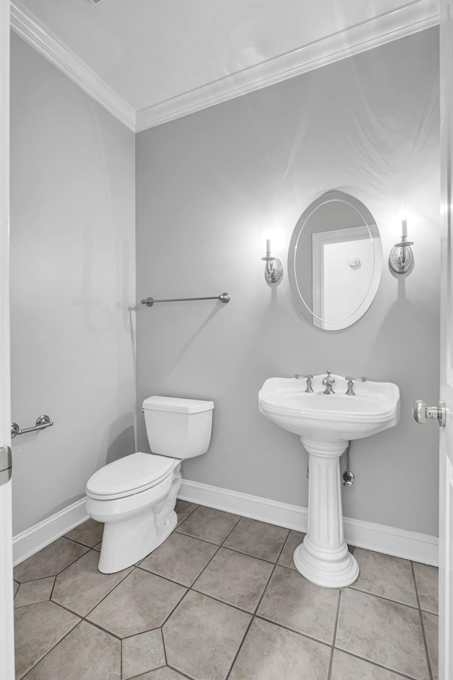 bathroom featuring crown molding, toilet, and tile patterned flooring