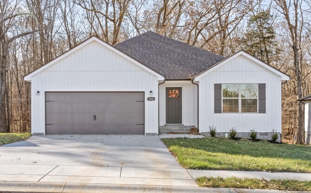 view of front of house with a garage and a front yard