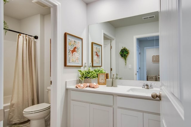 full bathroom featuring vanity, shower / tub combo, and toilet