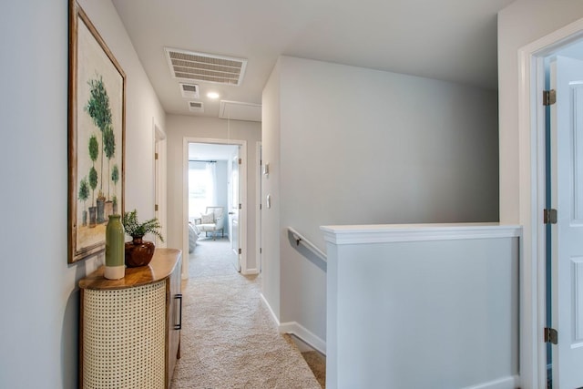 hallway with light colored carpet