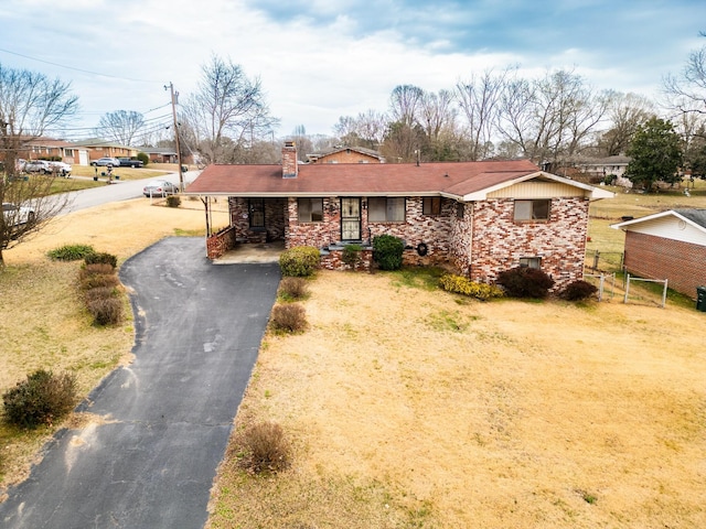 single story home with a front yard and a carport