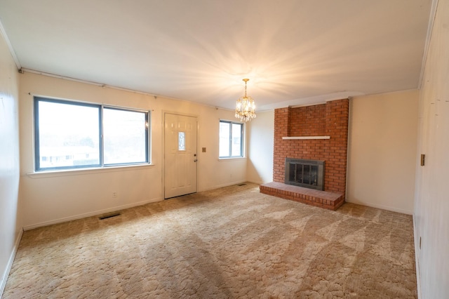 unfurnished living room featuring light carpet, a fireplace, and a chandelier