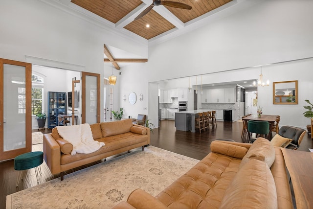 living room with coffered ceiling, a towering ceiling, wooden ceiling, and dark hardwood / wood-style floors