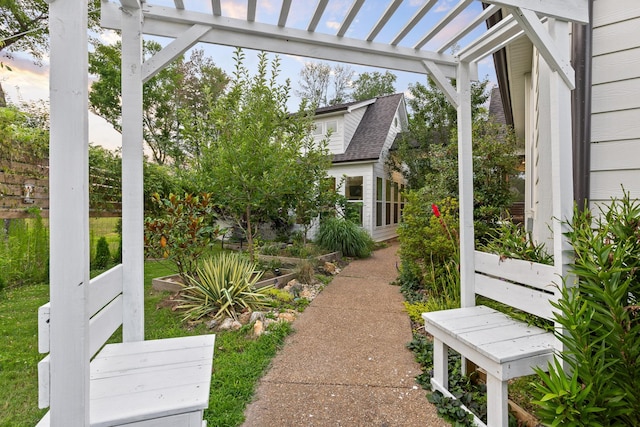 yard at dusk featuring a pergola