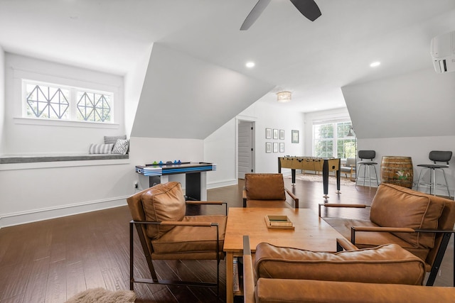 sitting room with lofted ceiling, ceiling fan, dark hardwood / wood-style floors, and a wall mounted AC