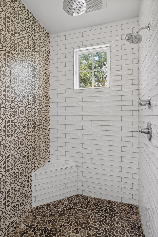 bathroom with a tile shower