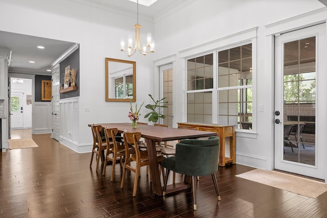 dining room featuring a notable chandelier, crown molding, and dark wood-type flooring