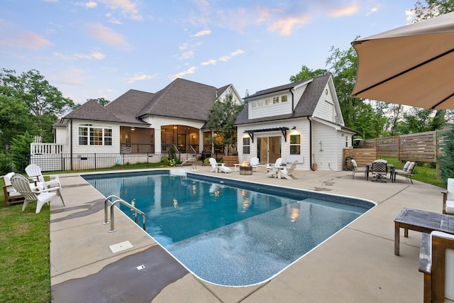 view of pool featuring an outbuilding and a patio