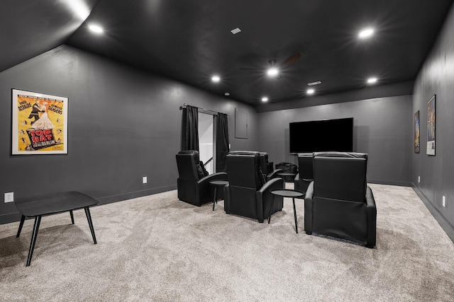 cinema with lofted ceiling and light carpet